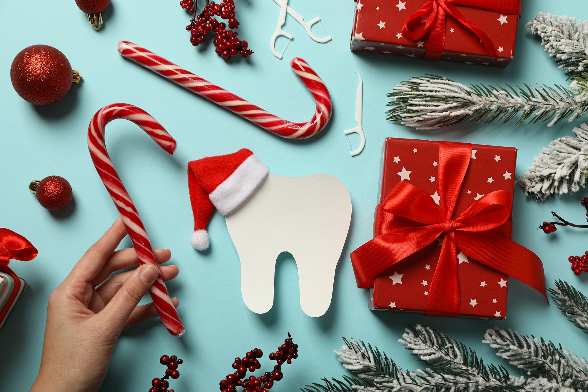 A tooth with Christmas decoration around it